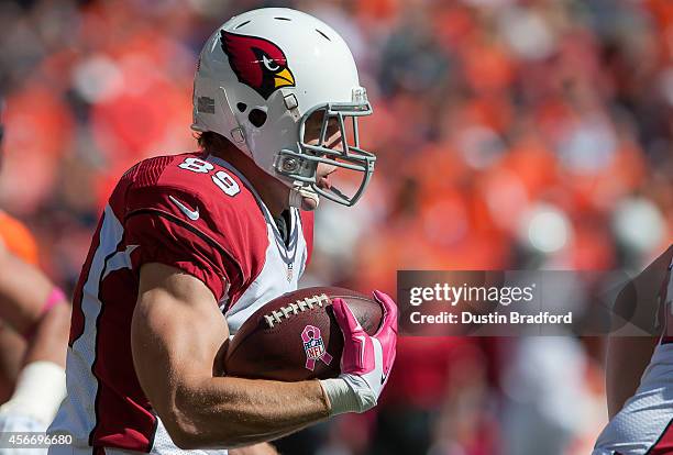 Tight end John Carlson of the Arizona Cardinals runs after a reception against the Denver Broncos at Sports Authority Field at Mile High on October...