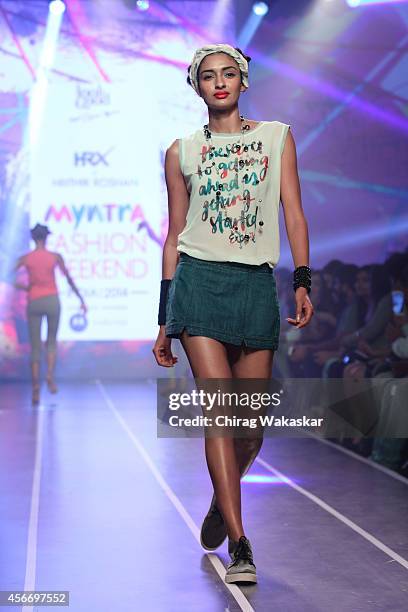 Model walks the runway at the HRX by Hrithik Roshan show during day 3 of Myntra Fashion Weekend 2014 at The Palladium Hotel on October 5, 2014 in...