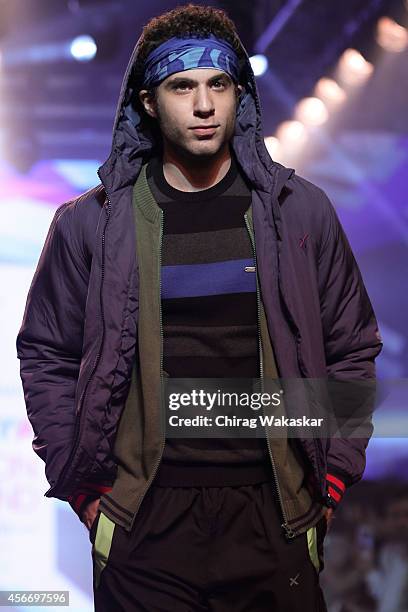 Model walks the runway at the HRX by Hrithik Roshan show during day 3 of Myntra Fashion Weekend 2014 at The Palladium Hotel on October 5, 2014 in...