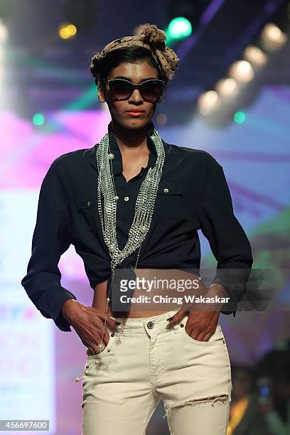 Model walks the runway at the HRX by Hrithik Roshan show during day 3 of Myntra Fashion Weekend 2014 at The Palladium Hotel on October 5, 2014 in...