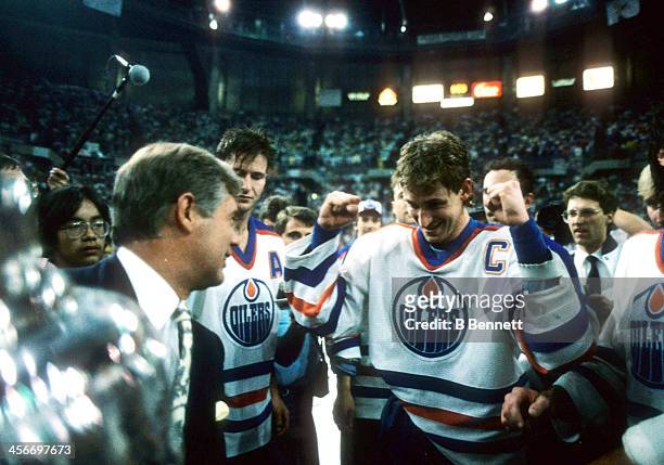 John Ziegler presents Wayne Gretzky of the Edmonton Oilers the Stanley Cup after the Oilers defeated the Philadelphia Flyers in Game 7 of the 1987...
