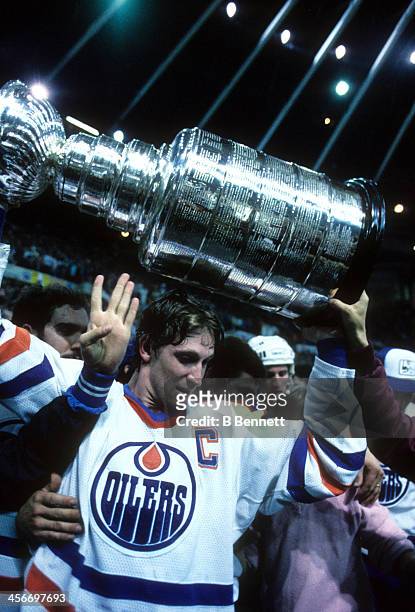 Wayne Gretzky of the Edmonton Oilers celebrates with the Stanley Cup after the Oilers defeated the Philadelphia Flyers in Game 7 of the 1987 Stanley...