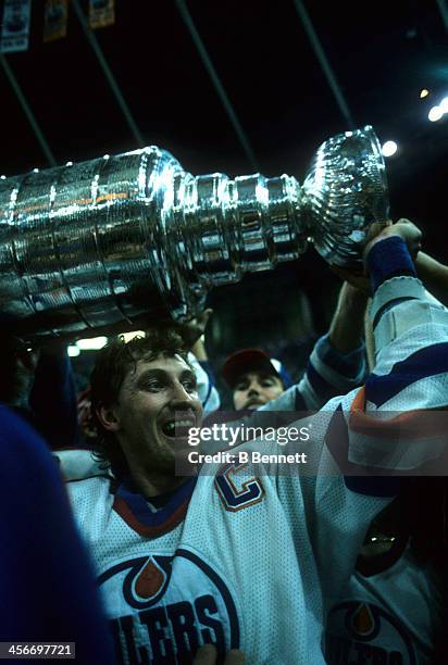 Wayne Gretzky of the Edmonton Oilers celebrates with the Stanley Cup after the Oilers defeated the Philadelphia Flyers in Game 7 of the 1987 Stanley...