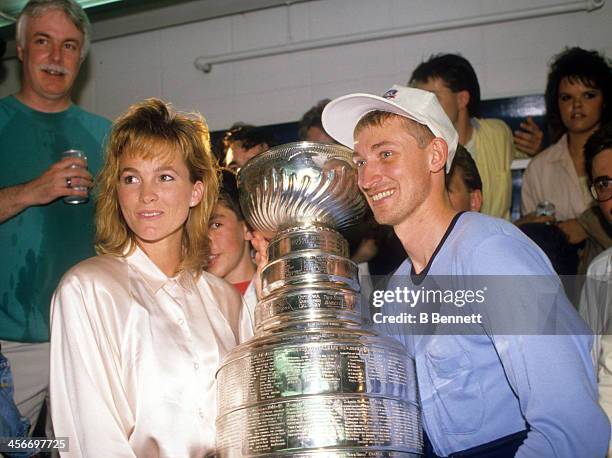 Wayne Gretzky of the Edmonton Oilers and wife Janet Jones celebrate after the Edmonton Oilers defeated the Boston Bruins in Game 5 of the 1988...