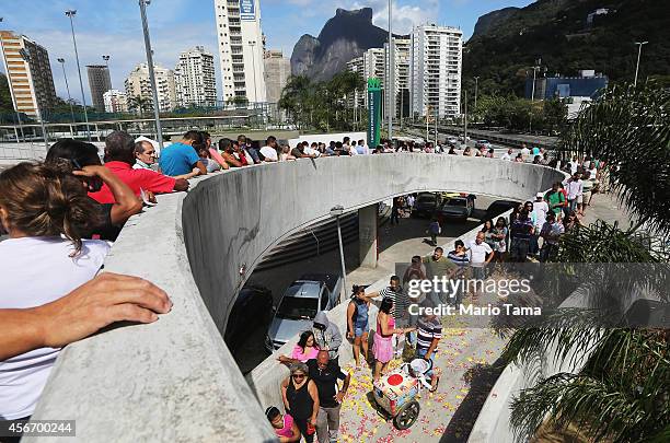 Brazilians wait in line to enter a polling station in the Rocinha favela, or community, on the day of national elections on October 5, 2014 in Rio de...