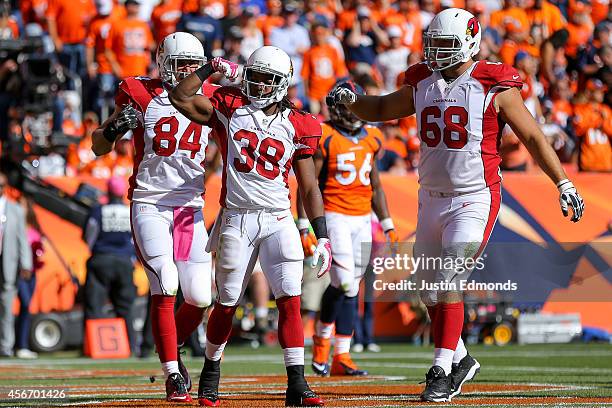 Running back Andre Ellington of the Arizona Cardinals celebrates a five-yard second-quarter touchdown run against the Denver Broncos with Jared...