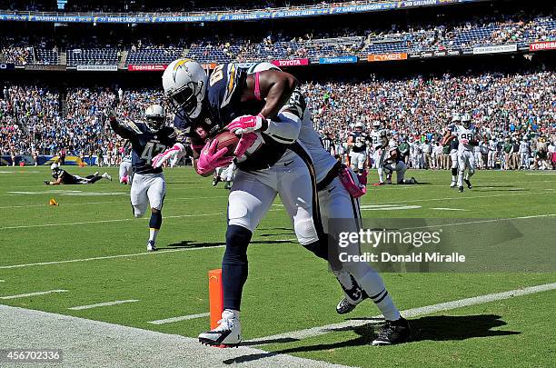 Antonio Gates of the San Diego Chargers catches a touchdown pass against Antonio Allen the New York Jets during their NFL game at Qualcomm Stadium on...