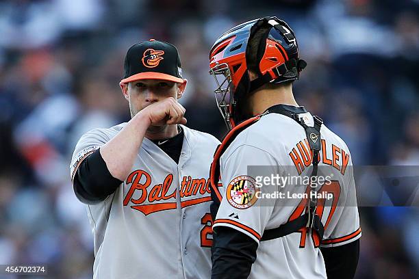 Bud Norris talks to Nick Hundley of the Baltimore Orioles on the mound in the fifth inning against the Detroit Tigers during Game Three of the...
