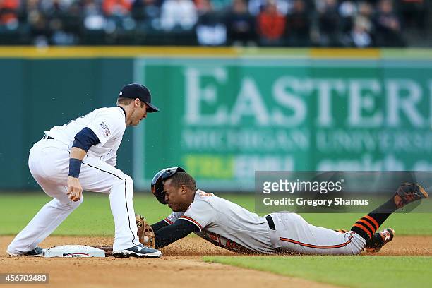 Jonathan Schoop of the Baltimore Orioles steals second base as Andrew Romine of the Detroit Tigers attempts to make the tag in the seventh inning...