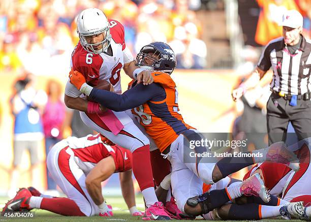 Quarterback Logan Thomas of the Arizona Cardinals is sacked by outside linebacker Von Miller of the Denver Broncos during a game at Sports Authority...