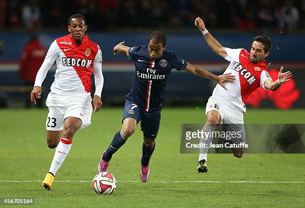 Lucas Moura of PSG in action between Anthony Martial and Joao Moutinho of Monaco during the French Ligue 1 match between Paris Saint-Germain FC and...