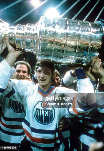 Wayne Gretzky of the Edmonton Oilers celebrates with the Stanley Cup Trophy after the Oilers defeated the New York Islanders in Game 5 of the 1984...