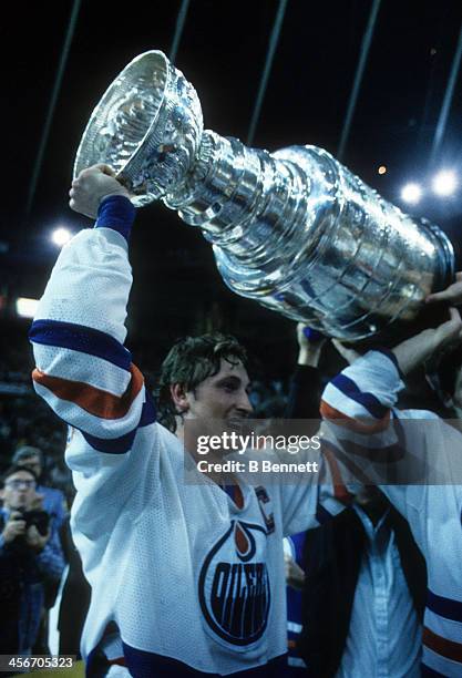 Wayne Gretzky of the Edmonton Oilers celebrates with the Stanley Cup Trophy after the Oilers defeated the New York Islanders in Game 5 of the 1984...