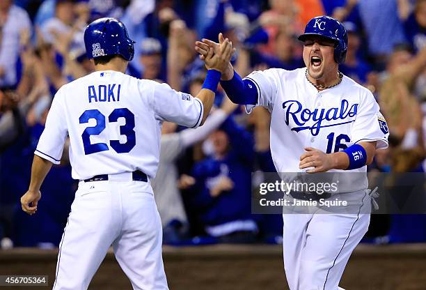Billy Butler celebrates with Norichika Aoki of the Kansas City Royals after scoring in the first inning against the Los Angeles Angels during Game...