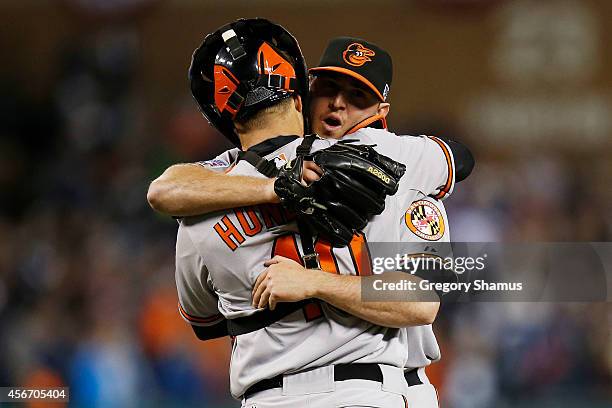 Zach Britton and Nick Hundley of the Baltimore Orioles celebrate their 2 to 1 win over the Detroit Tigers to sweep the series in Game Three of the...