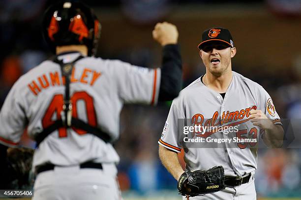 Zach Britton and Nick Hundley of the Baltimore Orioles celebrate their 2 to 1 win over the Detroit Tigers to sweep the series in Game Three of the...