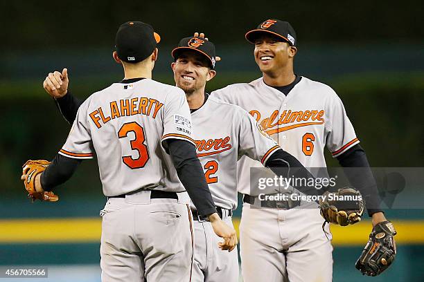 Ryan Flaherty, J.J. Hardy and Jonathan Schoop of the Baltimore Orioles celebrate their 2 to 1 win over the Detroit Tigers to sweep the series in Game...