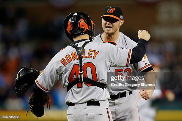 Zach Britton and Nick Hundley of the Baltimore Orioles celebrate their 2 to 1 win over the Detroit Tigers to sweep the series in Game Three of the...
