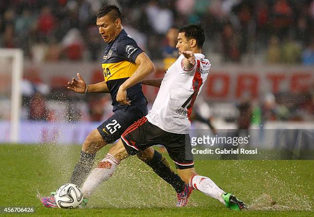 Gabriel Mercado of River Plate fights for the ball with Andres Chavez of Boca Juniors during a match between River Plate and Boca Juniors as part of...