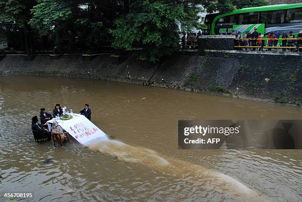 Indonesian artists perform a play in memory of Nelson Mandela's struggle and spirit, in the Cikapundung river next to the Merdeka Building where the...