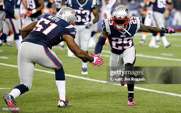 Kyle Arrington of the New England Patriots high fives Jerod Mayo after recovering a fumble and scoring a touchdown during the third quarter against...