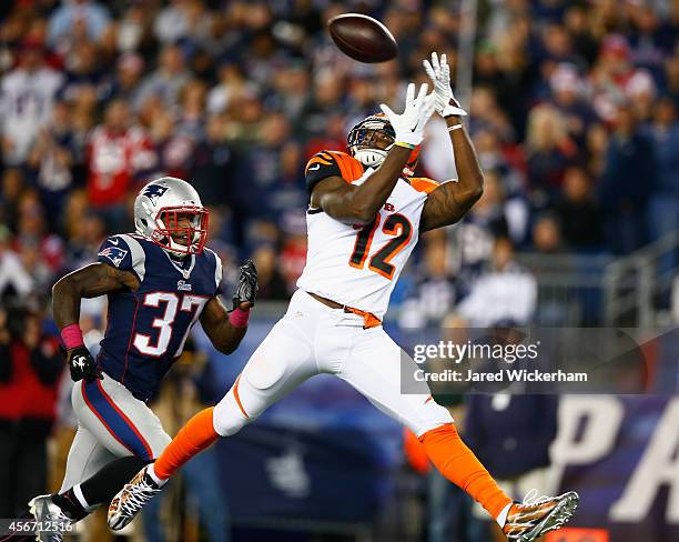 Mohamad Sanu of the Cincinnati Bengals catches a touchdown pass as Alfonzo Dennard of the New England Patriots defends during the third quarter at...