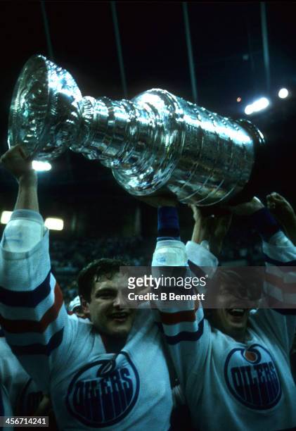 Esa Tikkanen and Jari Kurri of the Edmonton Oilers celebrate with the Stanley Cup after the Oilers defeated the Philadelphia Flyers in Game 7 of the...