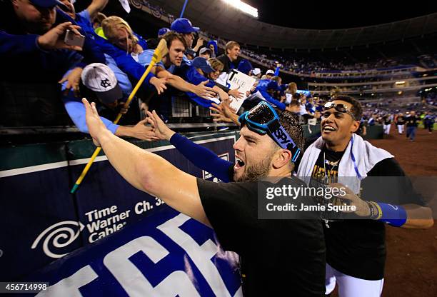 Mike Moustakas of the Kansas City Royals celebrates with fans after the Royals defeated the Los Angeles Angels 9-3 to win game 3 of the American...