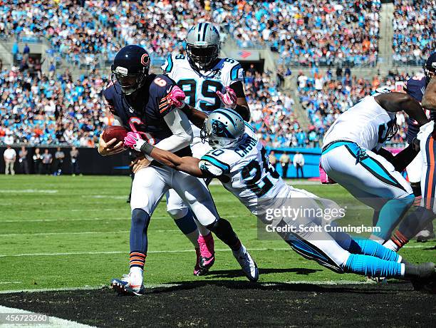 Jay Cutler of the Chicago Bears carries the ball for a touchdown against Antoine Cason of the Carolina Panthers on October 5, 2014 at Bank of America...