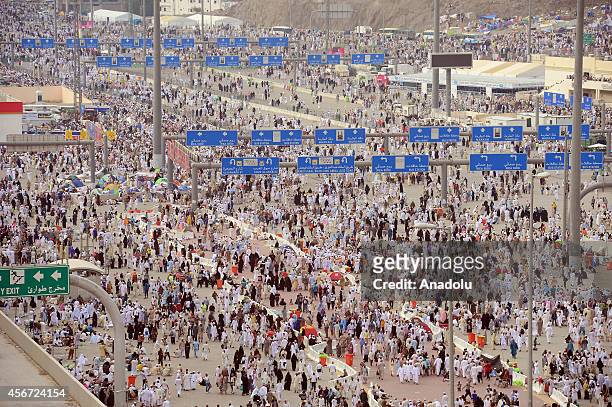 Muslim pilgrims walk near the Jamarat Bridge used by Muslims during the stoning of the devil ritual of the Hajj at the third day of Eid al-Adha in...