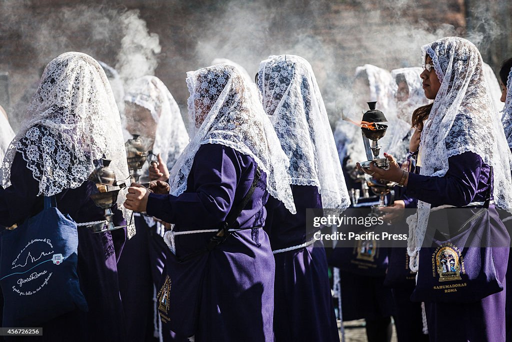 Peruvian women, known as "Sahumadoras", burn incense while...