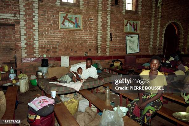 Refugees wait on June 28, 1994 in the Sainte-Famille church where thousands of Tutsi and Hutu have taken refuge during the Rwandan genocide.