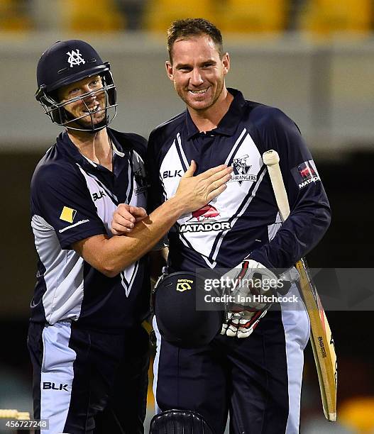 Cameron White and John Hastings celebrate after winning the Matador BBQs One Day Cup match between Victoria and South Australia at The Gabba on...