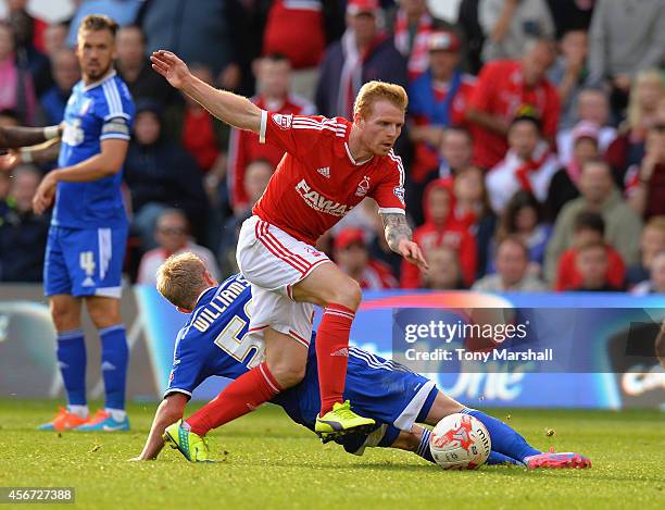 Chris Burke of Nottingham Forest is tackled by Jonny Williams of Ipswich Town during the Sky Bet Championship match between Nottingham Forest and...
