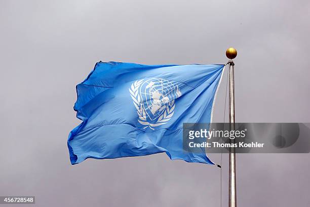 Flag of the United Nations in front of grey clouds on top of the United Nations Secretariat at the headquarters of the United Nations on September 24...