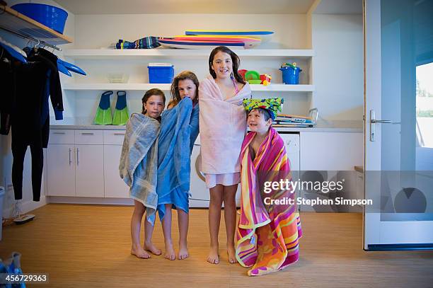 siblings in towels in their beach/washroom - envuelto en una toalla fotografías e imágenes de stock