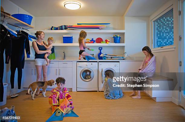 after the beach, family scattered in laundry room - san diego homes stock pictures, royalty-free photos & images