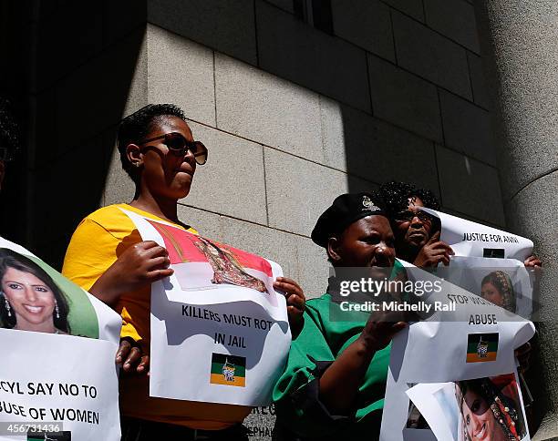 People protest outside the Western Cape High Court during the start of the trial of Shrien Dewani, on October 6, 2014 in Cape Town, South Africa. The...