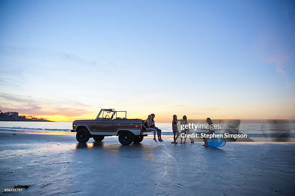 Girls talking, sunset, end of the day at the beach