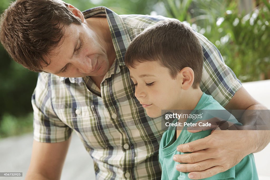 Father comforting son