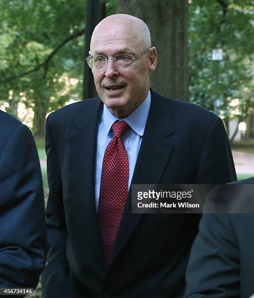 Former US Treasury Secretary Henry Paulson walks to the U.S. Court of Federal Claims October 6, 2014 in Washington, DC. Paulson will be a witness and...