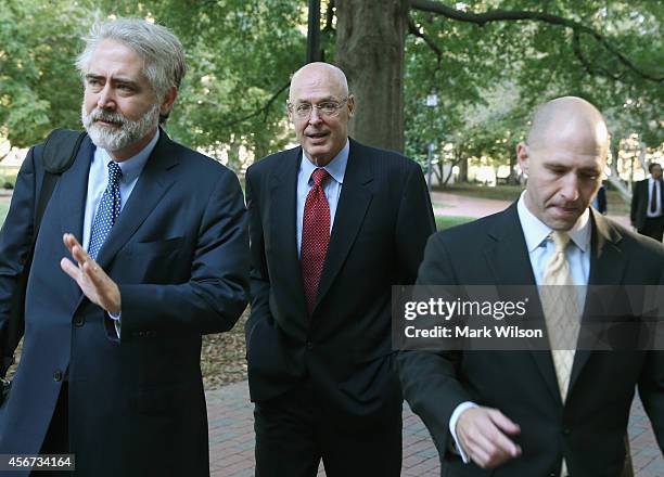 Former US Treasury Secretary Henry Paulson walks with his legal team to the U.S. Court of Federal Claims October 6, 2014 in Washington, DC. Paulson...