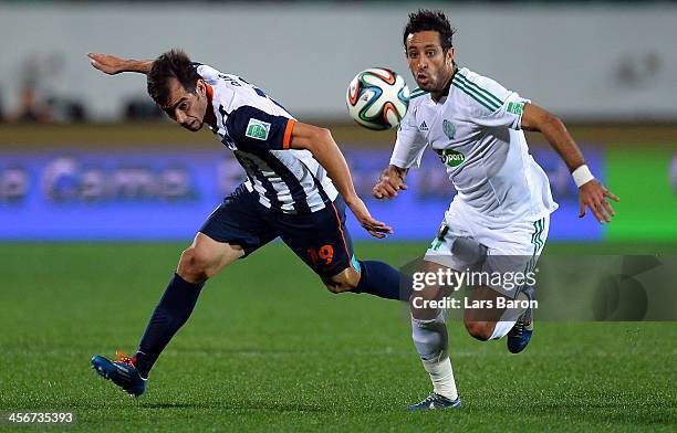 Cesar Delgado of Monterrey is challenged by Adil Karrouchy of Casablanca during the FIFA Club World Cup Quarterfinal match between Raja Casablanca...