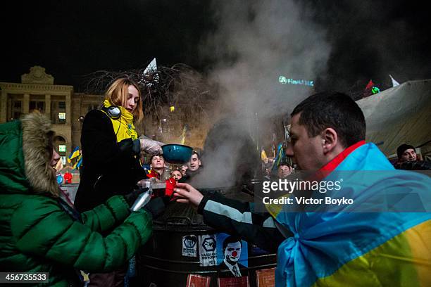 Volunteers distribute hot tea to protesters on Maidan Square on December 14, 2013 in Kiev, Ukraine. Anti-government protests began three weeks ago...