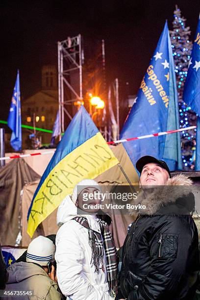 Protesters watch the TV screen on Maidan Square on December 14, 2013 in Kiev, Ukraine. Anti-government protests began three weeks ago when Ukrainian...