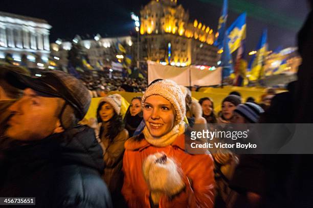 Woman claps in support of Okean Elzy rock band as they perfom on stage in Maidan Square as protests continue on December 14, 2013 in Kiev, Ukraine....