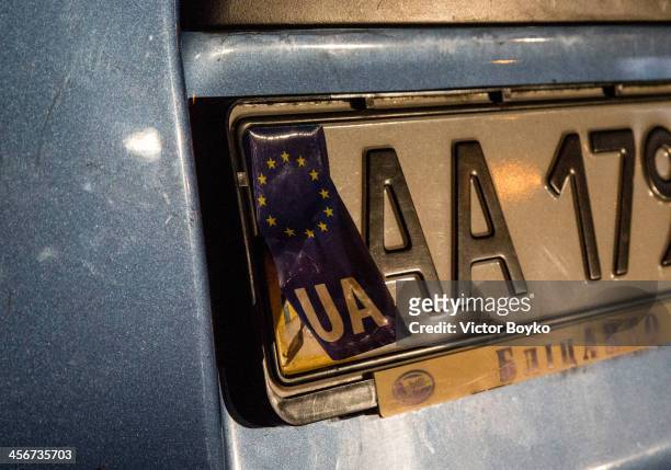 Makeshift license plate sticker with the European Union flag covers a part of a license plate on a car near Maidan Square on December 14, 2013 in...