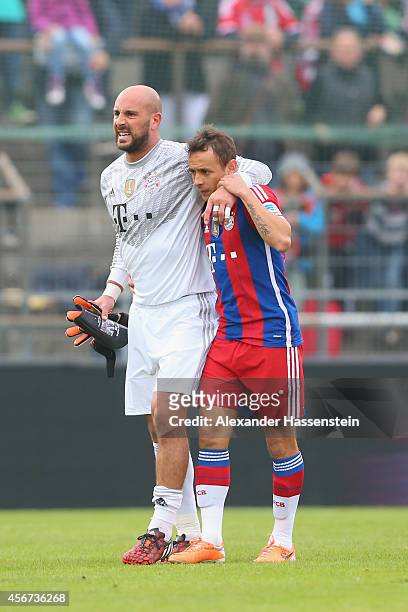Pepe Reina, keeper of Muenchen receives medical treatment from his team mate Rafinha after getting injured during the Finale of the Paulaner Cup 2014...