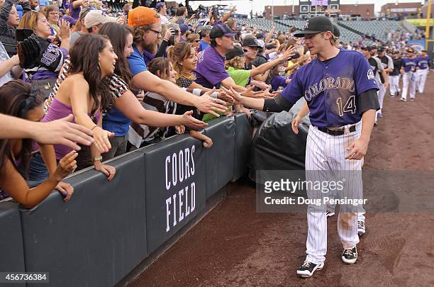 Manager Walt Weiss of the Colorado Rockies greet the fans after facing the Arizona Diamondbacks in the last home game of the season at Coors Field on...