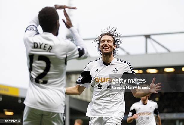 Nathan Dyer of Swansea City is congratulated by teammate Michu after scoring his side's first goal during the Premier League match between Norwich...